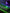 Mechanical gaming keyboard with green RGB backlight and wireless headphones on a desk.