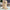 Wooden bookend on a glass surface with a blurred indoor background