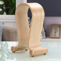 Wooden bookend on a glass surface with a blurred indoor background